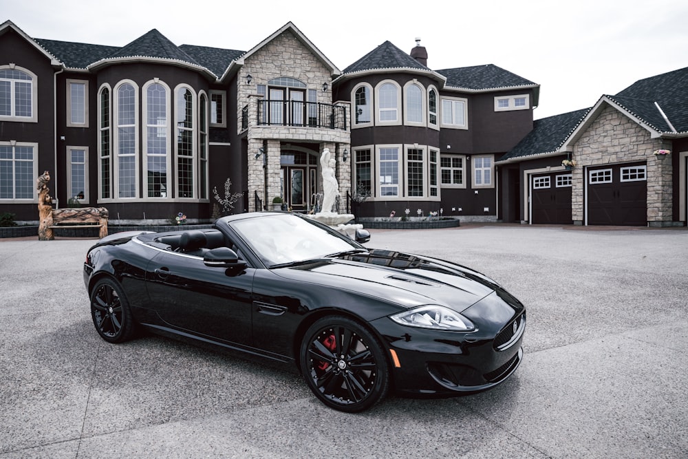 black convertible coupe parked near house