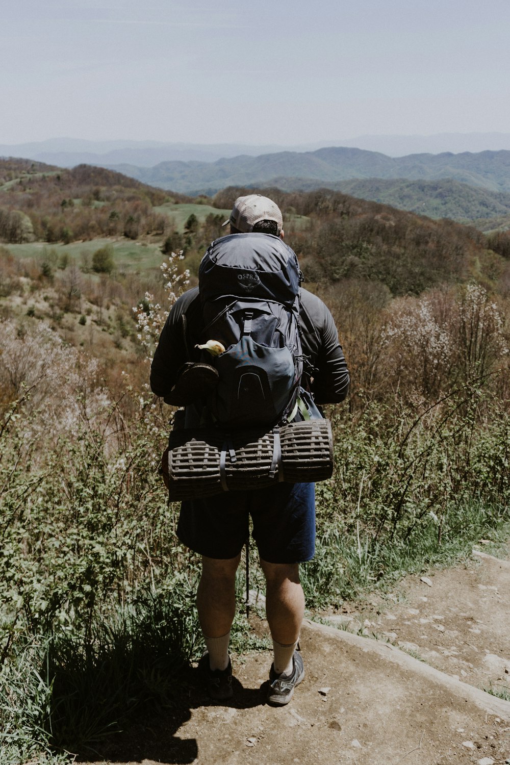 man carrying black backpack