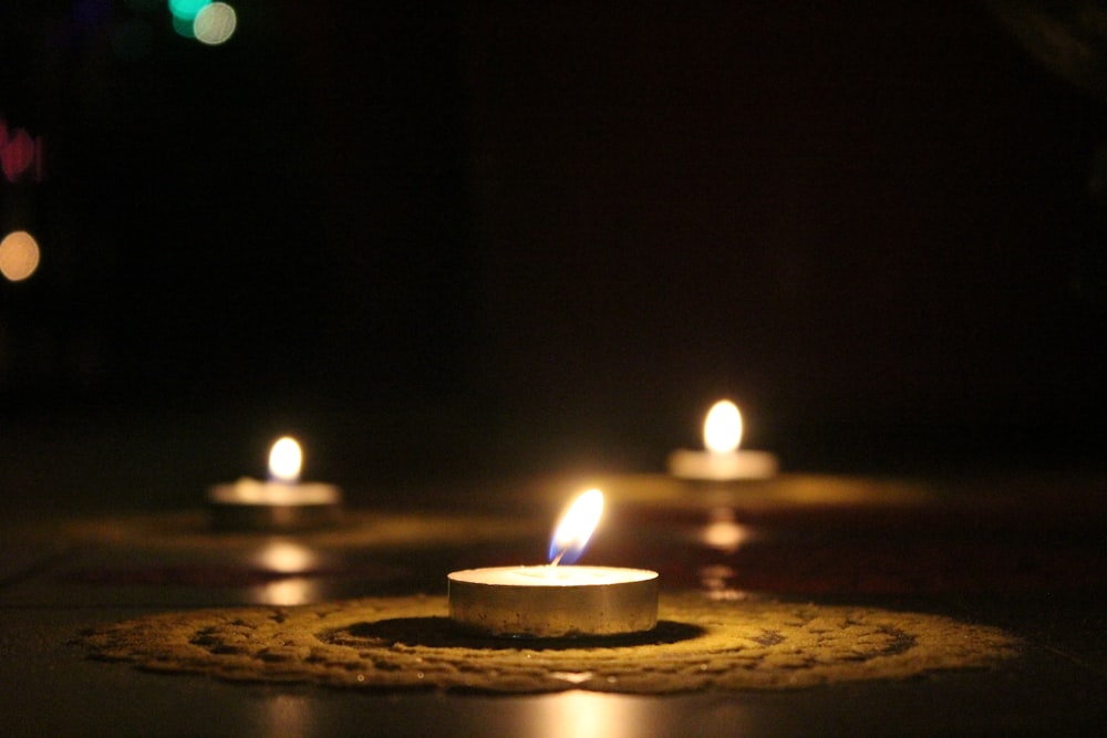 three white tealight candles