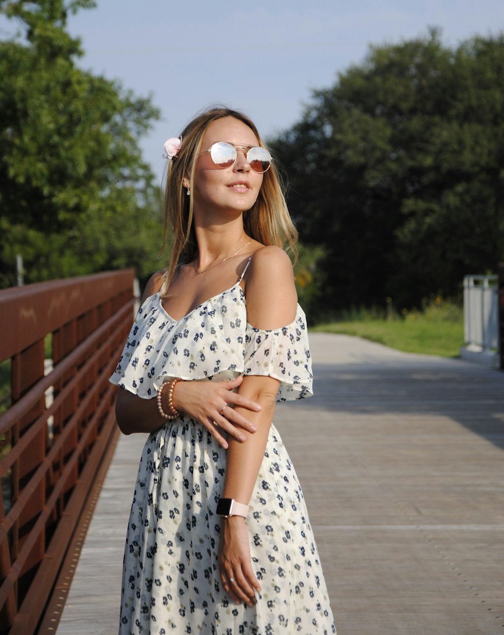 woman wearing white and blue floral cold-shoulder dress