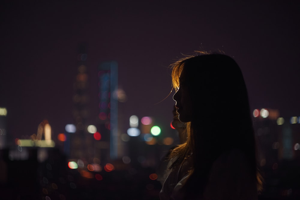 silhouette of woman standing near building