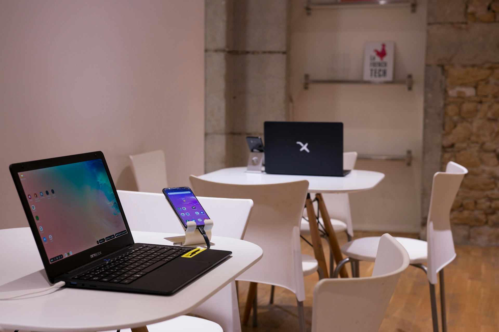 black laptop computer on white wooden table