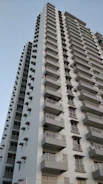 low-angle photography of white and gray concrete high-rise building