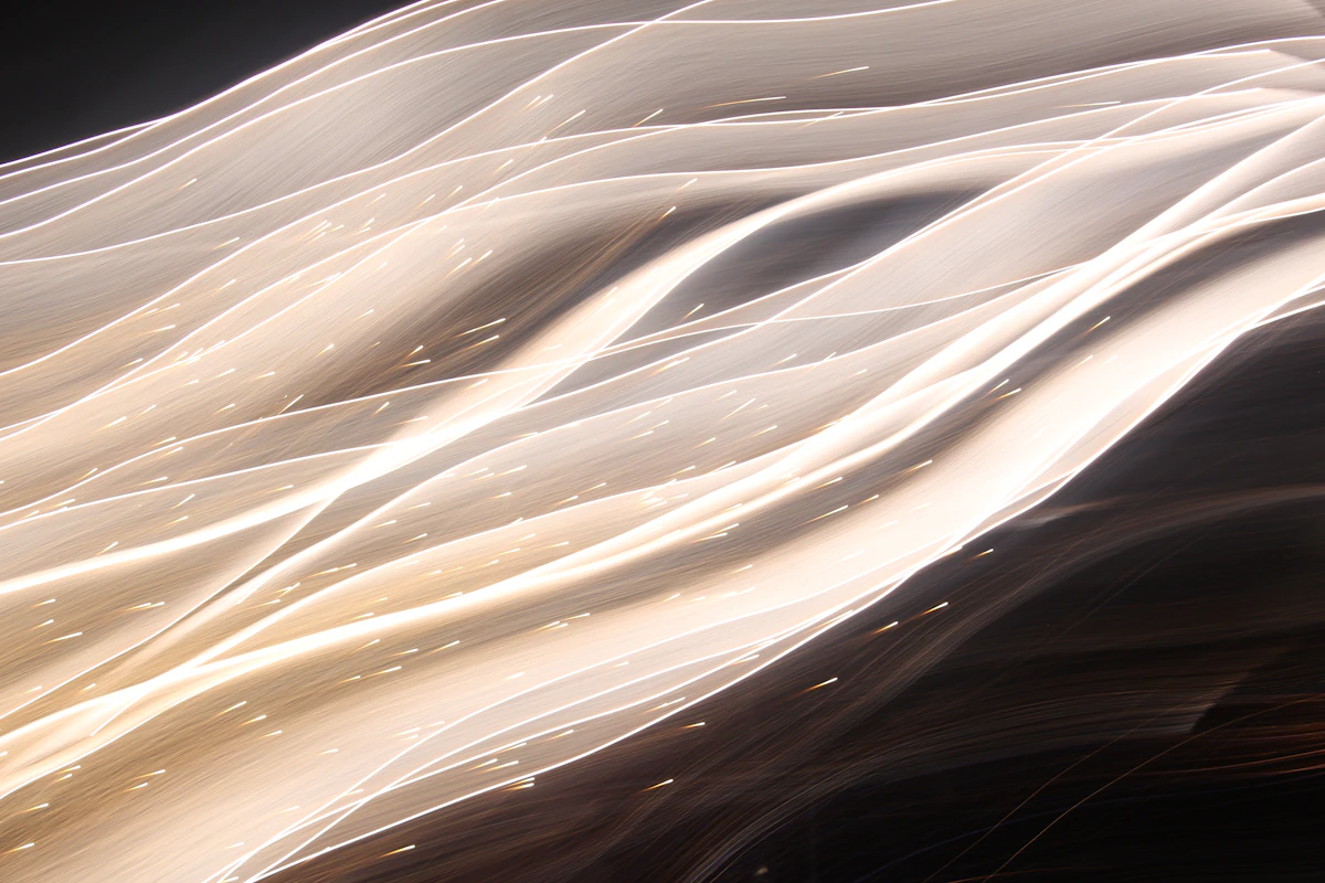 Blurred white light lines on a black background
