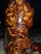 A clear glass jar filled with tightly packed dates, showcasing their rich, brown color and slightly glossy texture. The arrangement creates a dense, organic appearance, with each date's wrinkled skin and natural shape visible through the glass.