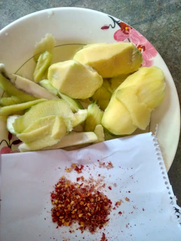 Close-up of a vibrant amras puri plate with fresh mango pulp dripping over crispy puris.