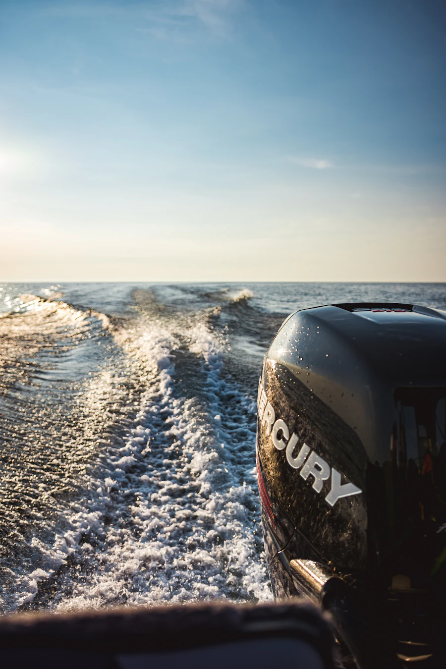 Black outboard motor on the back of a boat