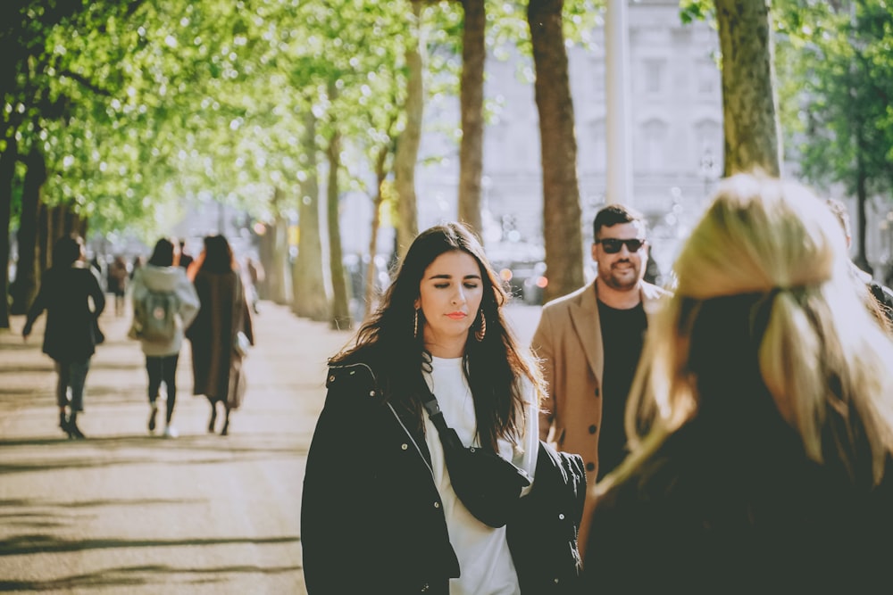 people walking between trees