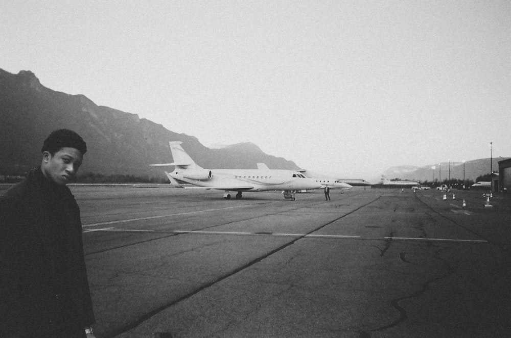 man standing near parked airplane