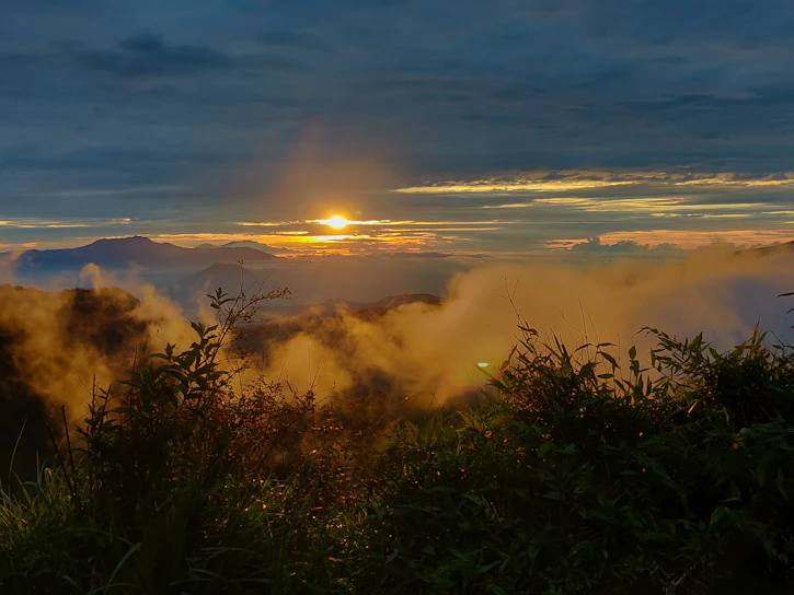 A breathtaking sunrise casting golden light over a misty mountain range.