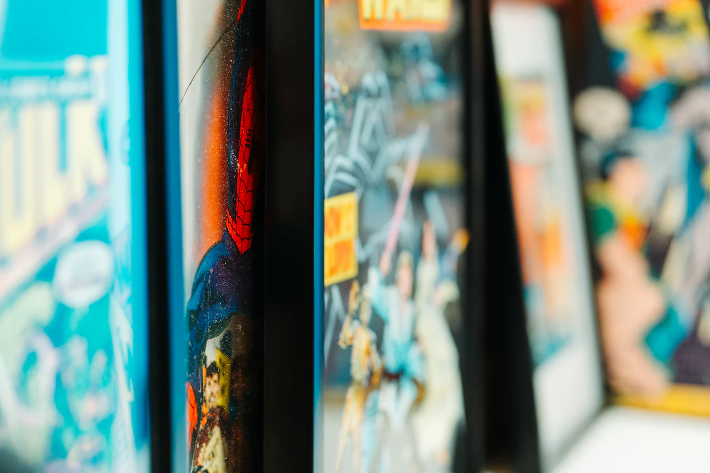 A close row of comic book spines on a shelf