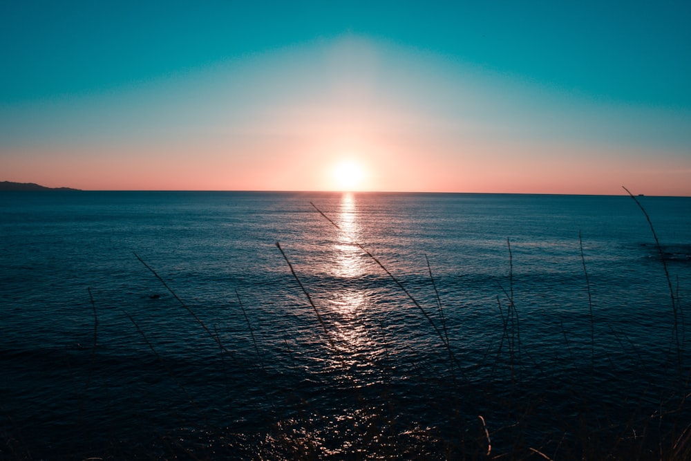 blue sea during sunrise