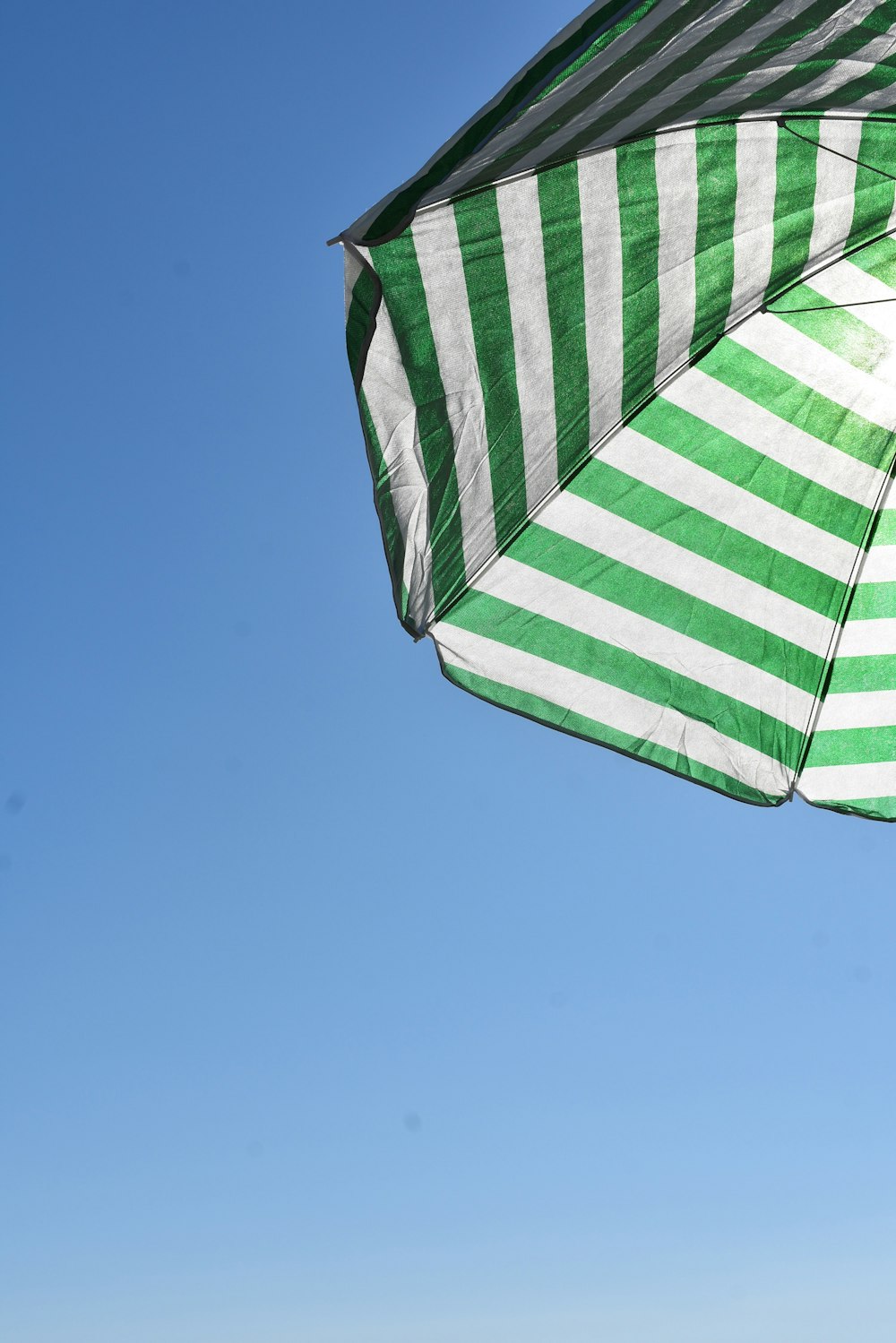 white and green striped umbrella