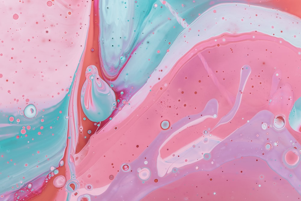 a close up of a pink and blue liquid