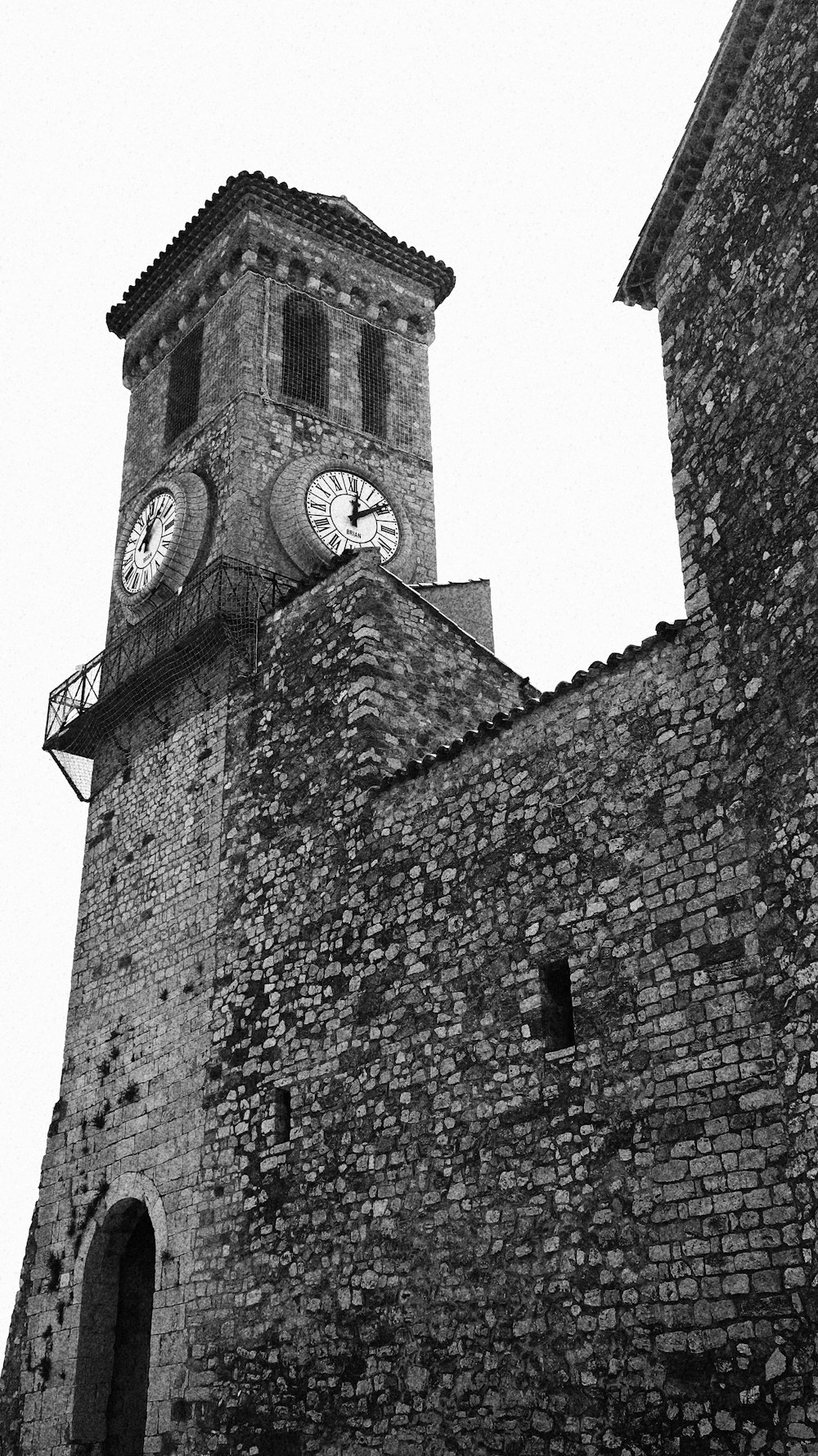 greyscale photo of stone building