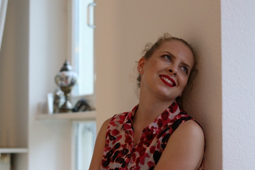 woman wearing white and red floral blouse