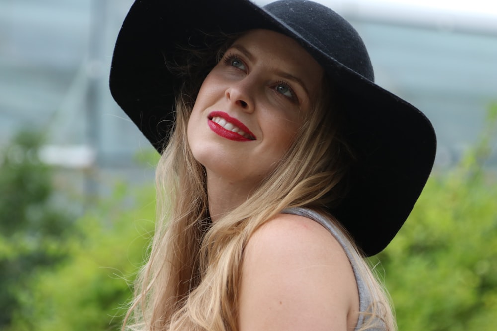 woman smiling wearing black hat
