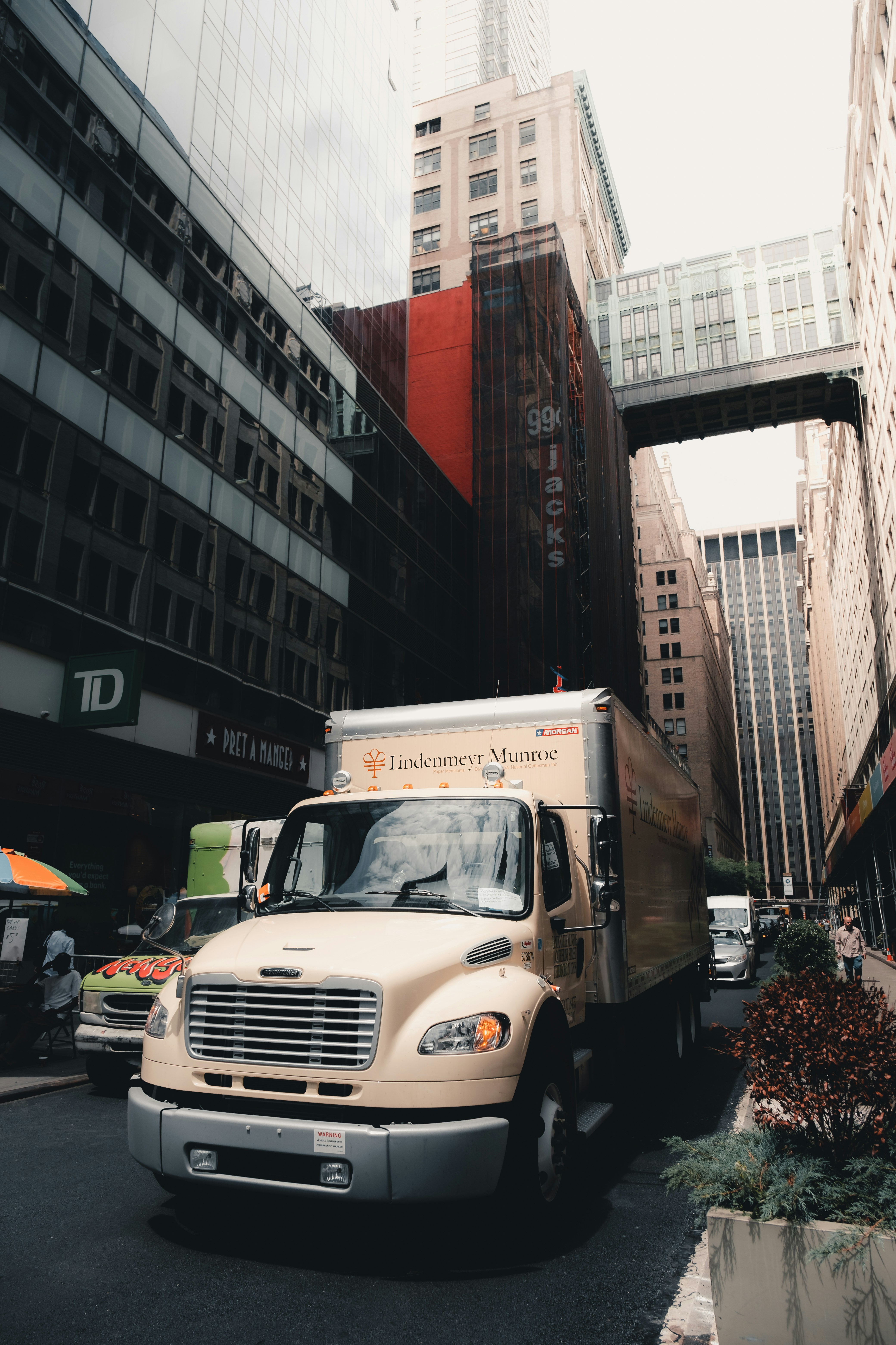 beige box truck parked along side the road