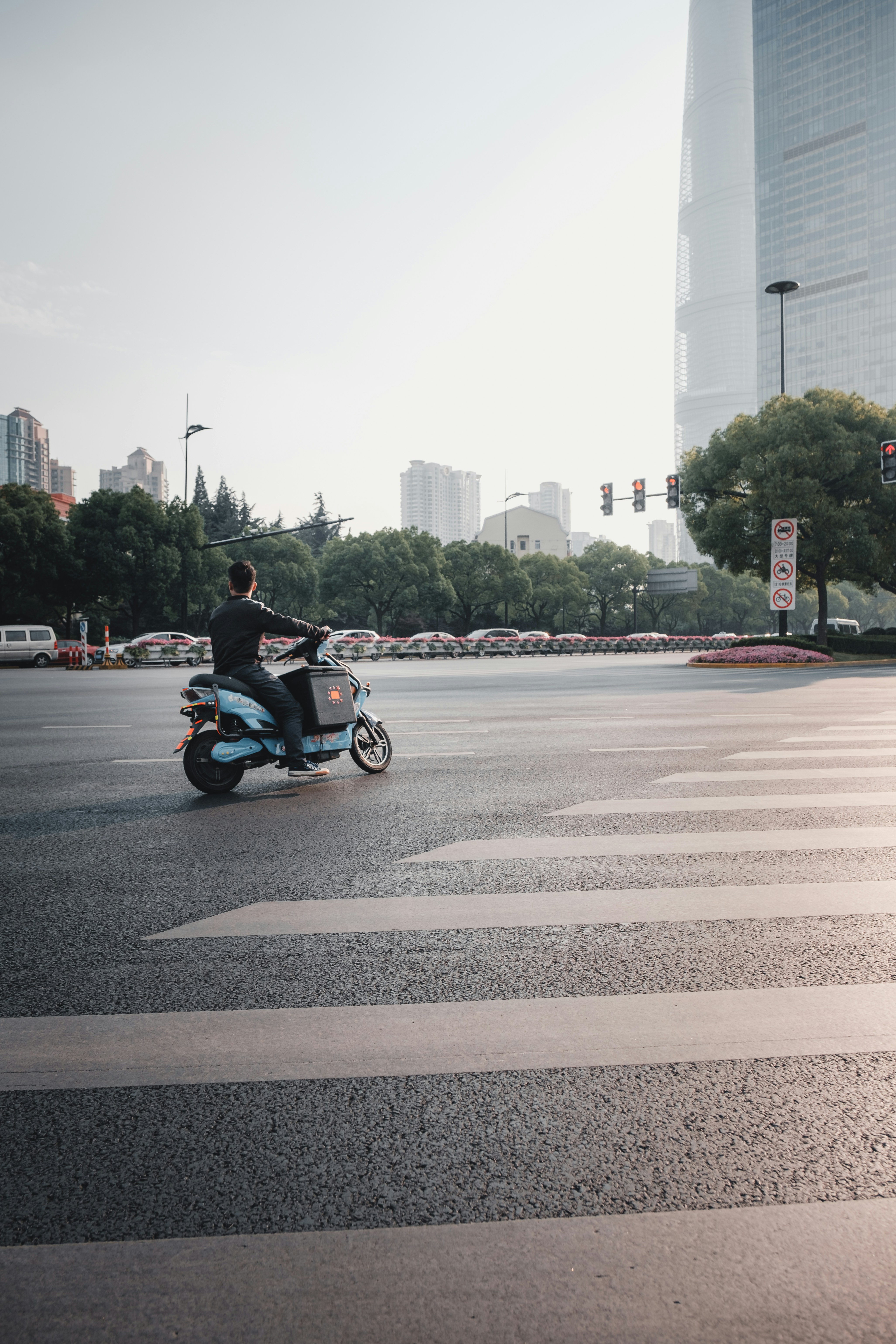 man riding motorcycle near pedestrian lane