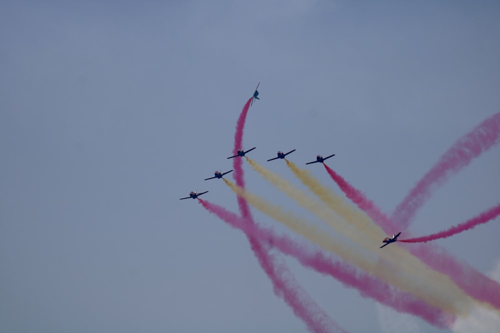 planes emitting colored smokes