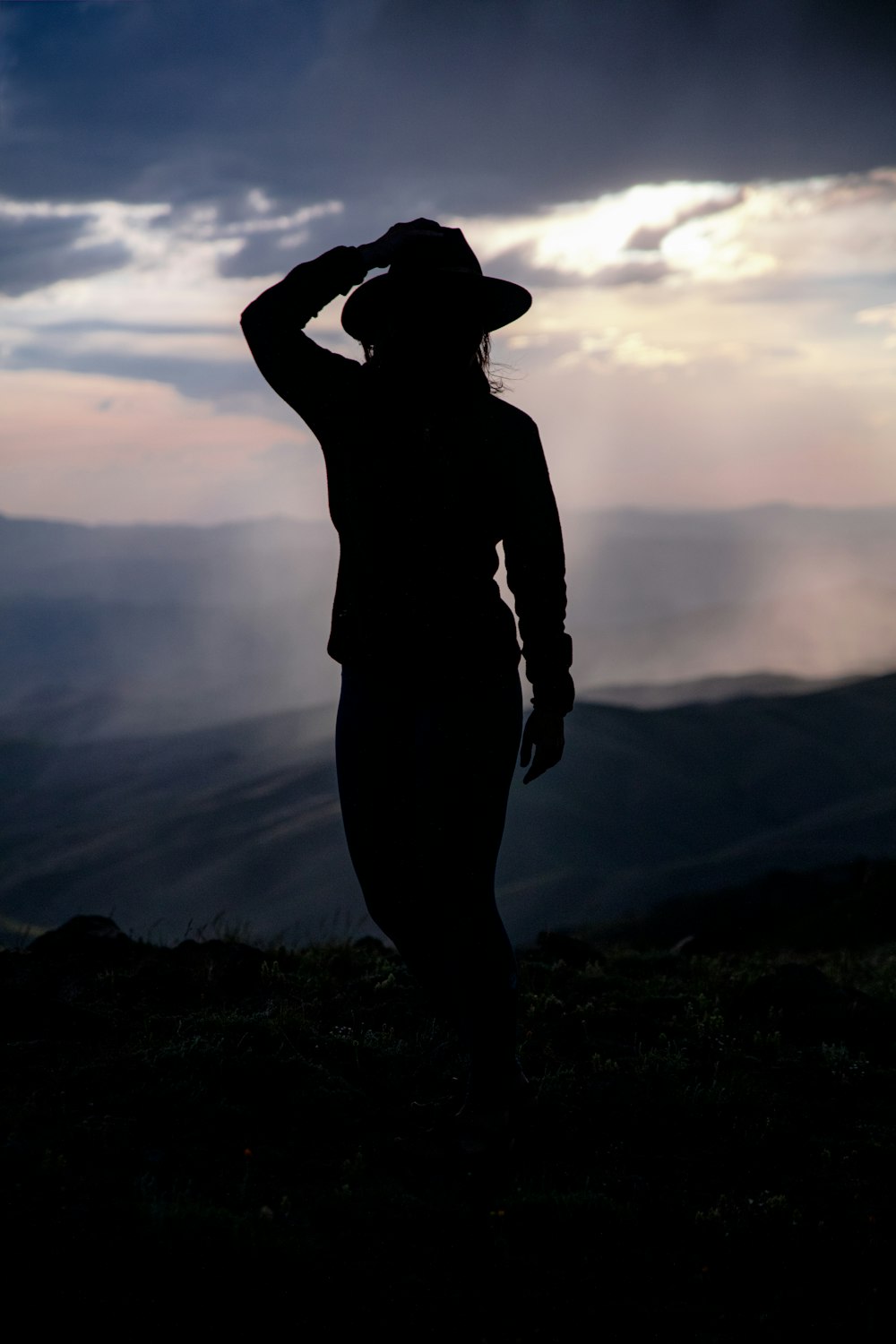 silhouette of woman near mountains