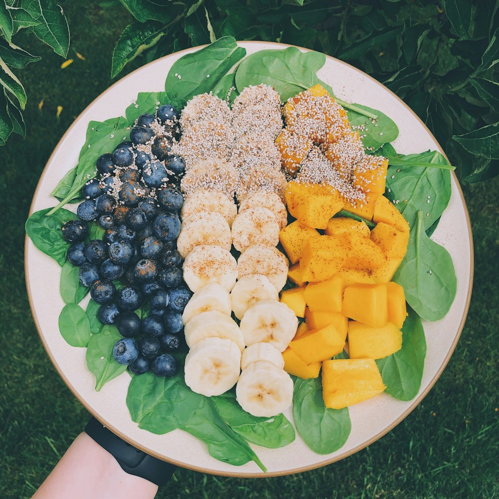 sliced blueberries, banana, and pineapple fruits in plate