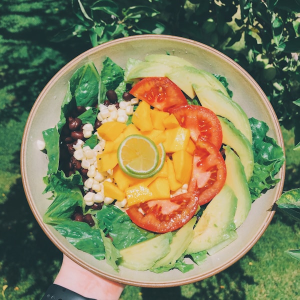 Veggie salad in white and brown ceramic plate