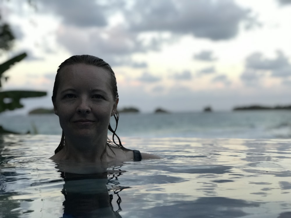 shallow focus photo of woman in body of water