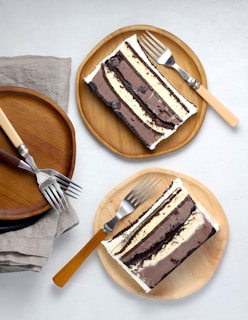 sliced cakes on round brown wooden plates