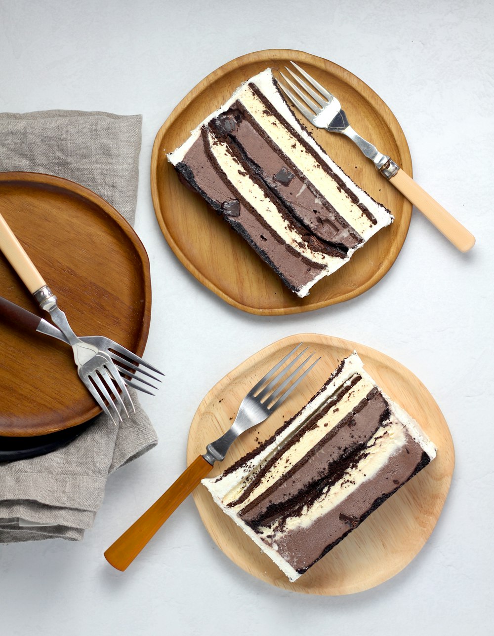 sliced cakes on round brown wooden plates