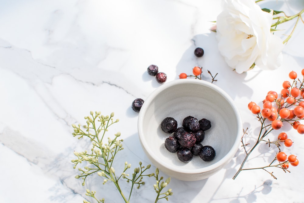 blue berries on white ceramic bowl