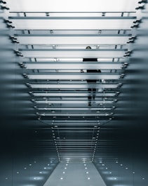 person on glass stair photo