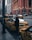A busy city street scene with yellow taxis lined up.