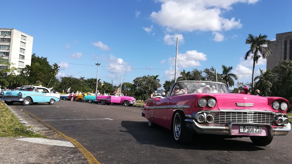pink convertible coupe on gray top road