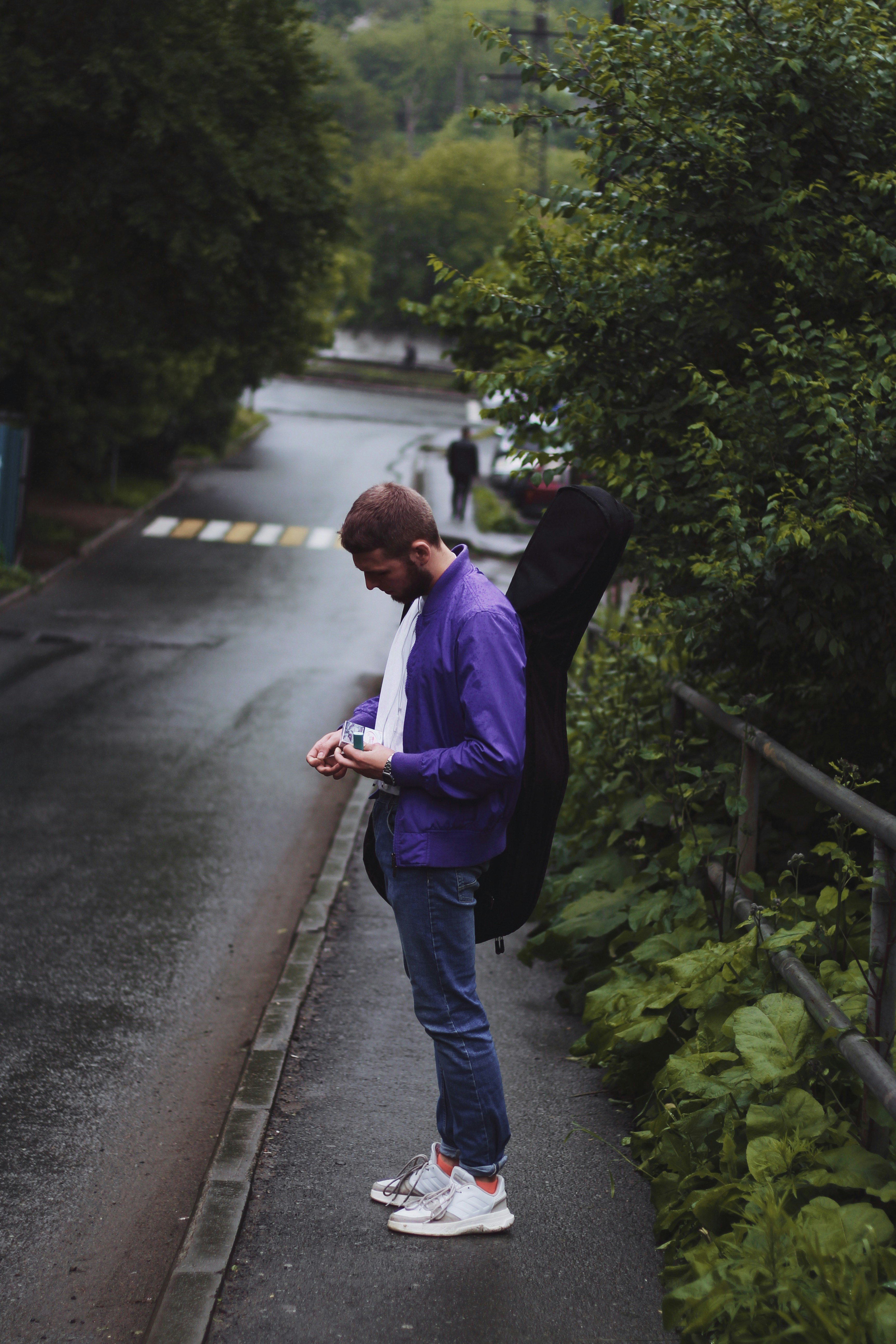 man standing on road