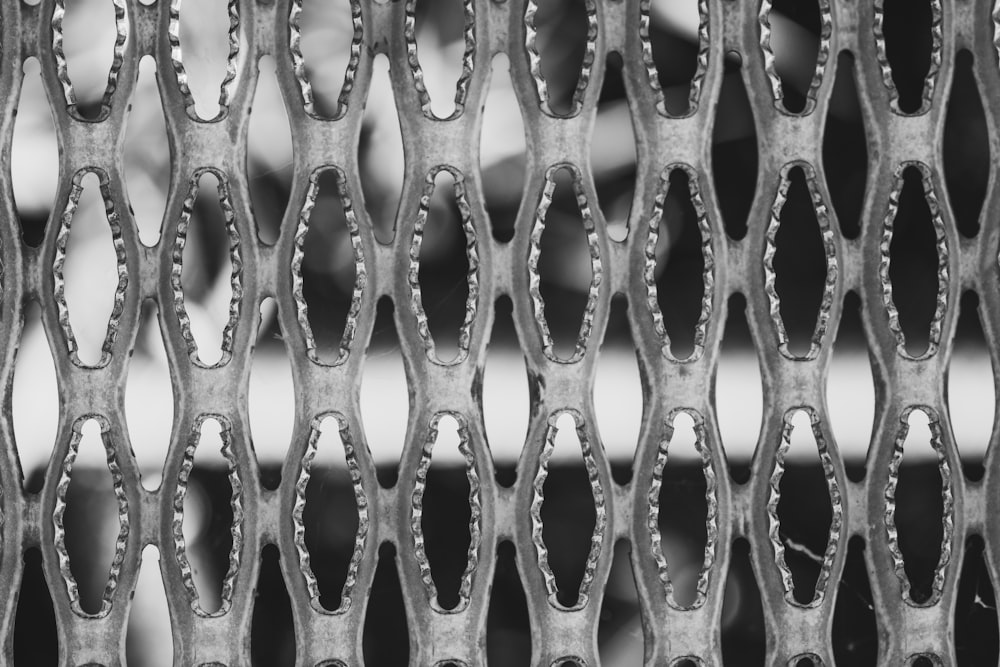 a close up of a metal grate with holes