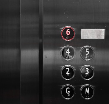 a close up of a metal elevator with buttons