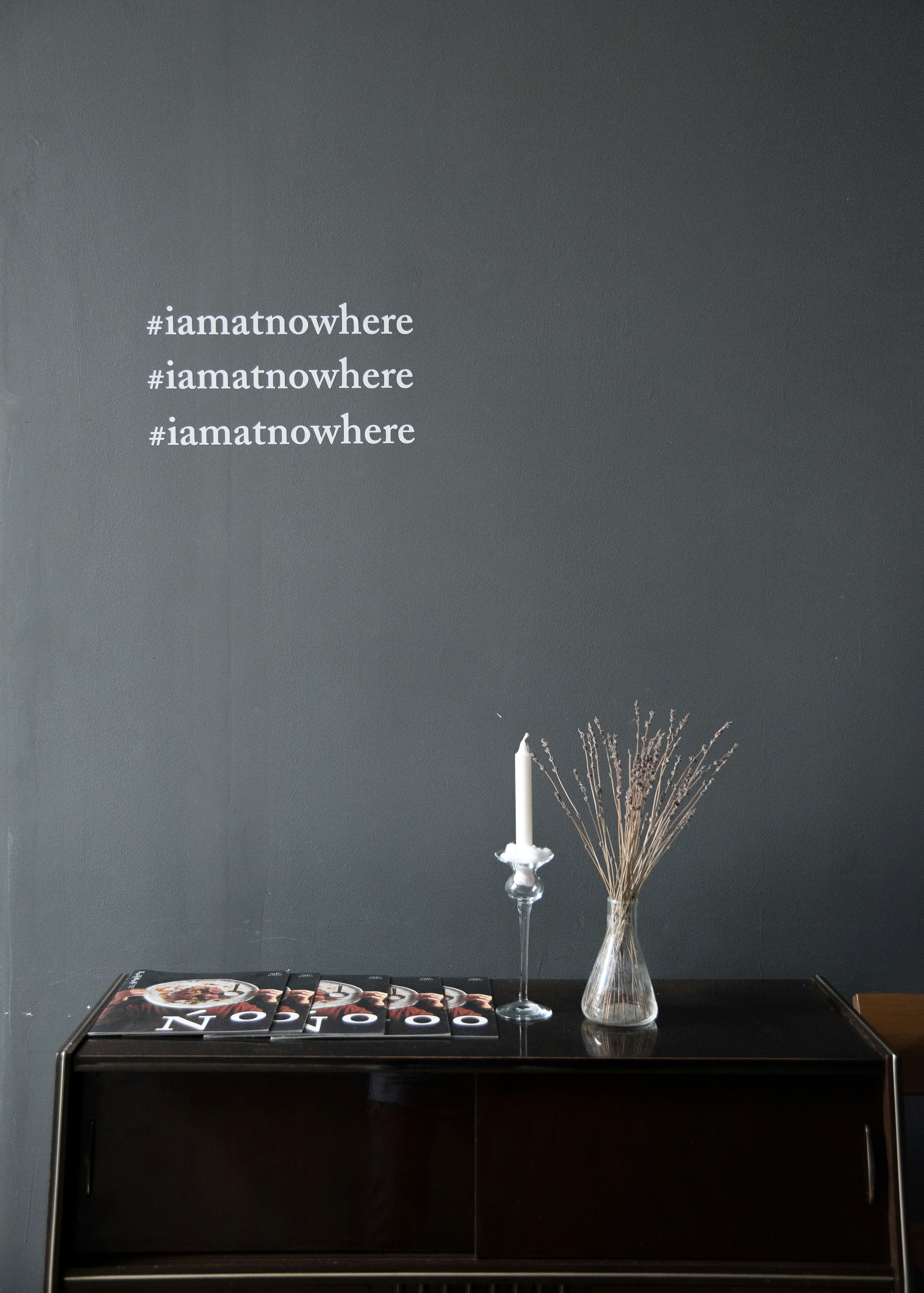 It's a sentence appearing on Grey concrete wall.