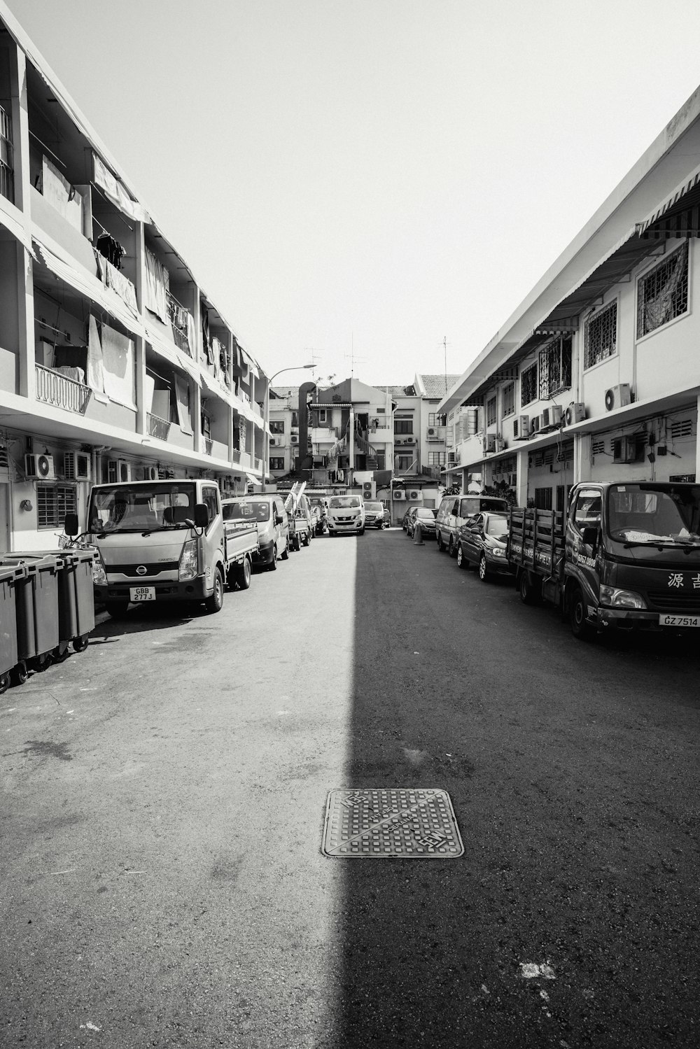 grayscale photo of trucks