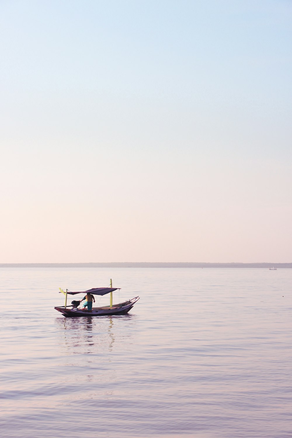 rule of thirds photography unknown person riding on boat