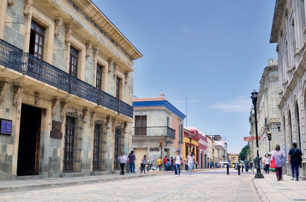 people walking on street under clear blue sky