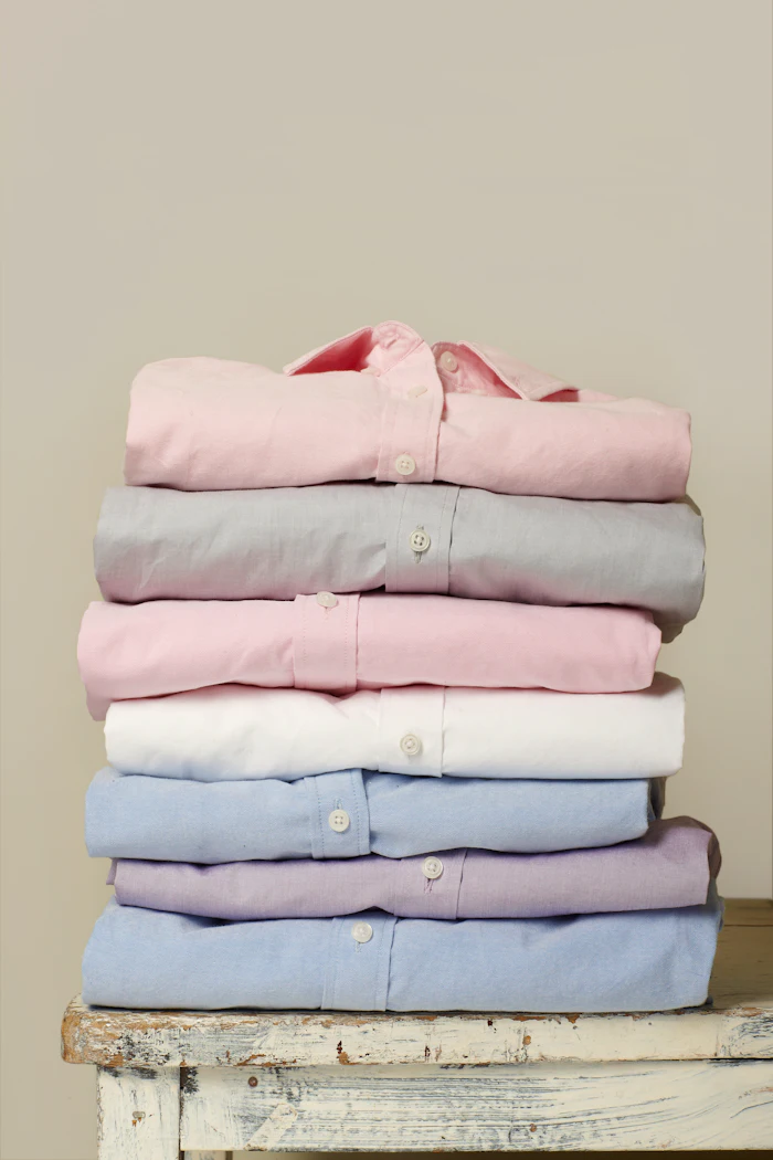 Pressed and folded shirts stacked ready for packing