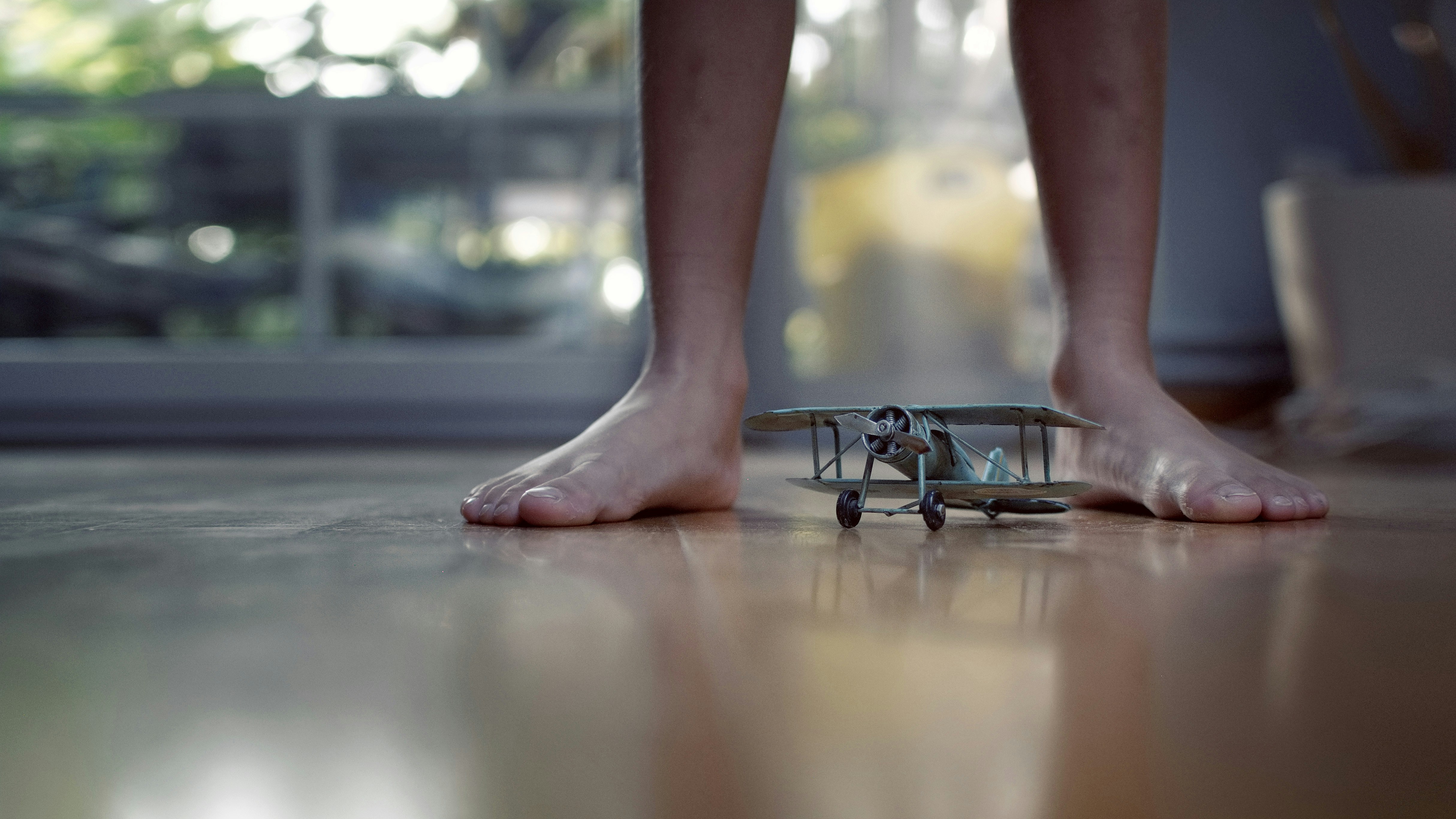 grey biplane scale model on floor, Dream big
