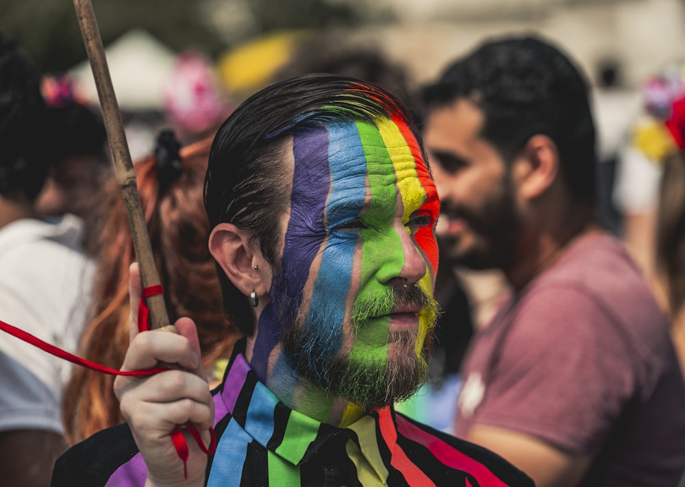 man wearing multicolored face paint