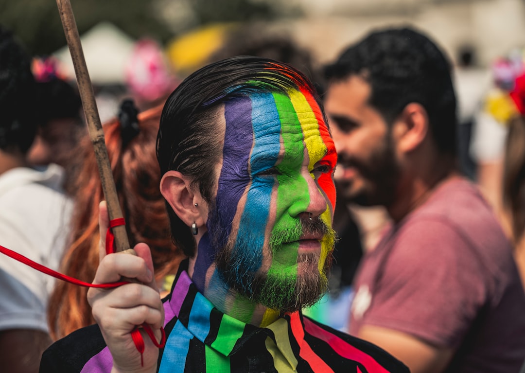 man wearing multicolored face paint