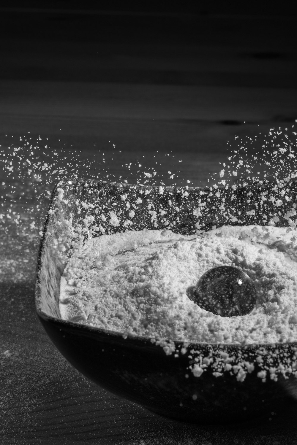 glass bowl drops in bowl of flour