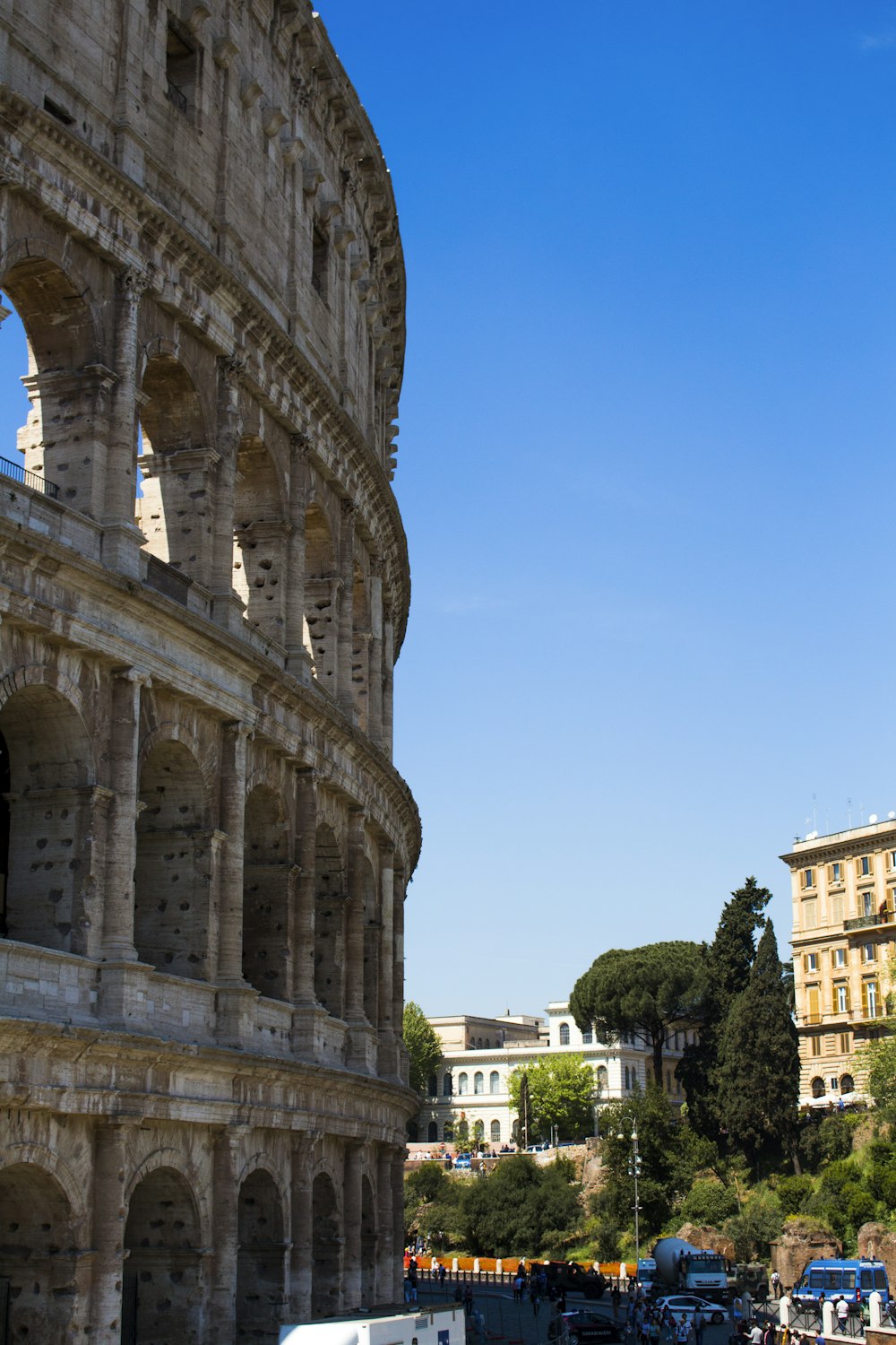 people and vehicles near Colosseum during daytime