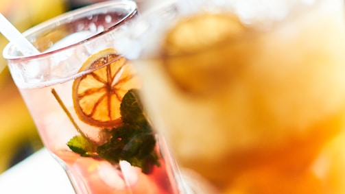Close-up of refreshing beverages being poured into glasses.