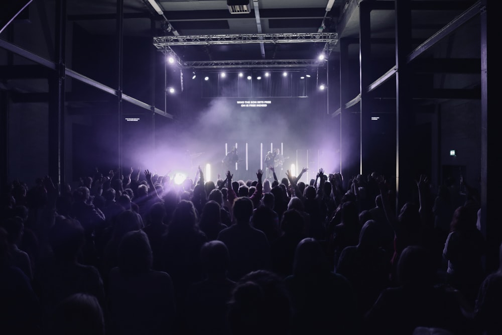 group of people performing on stage in front of crowd