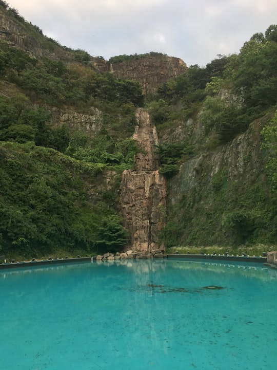 body of water under white sky in 용마폭포공원 South Korea